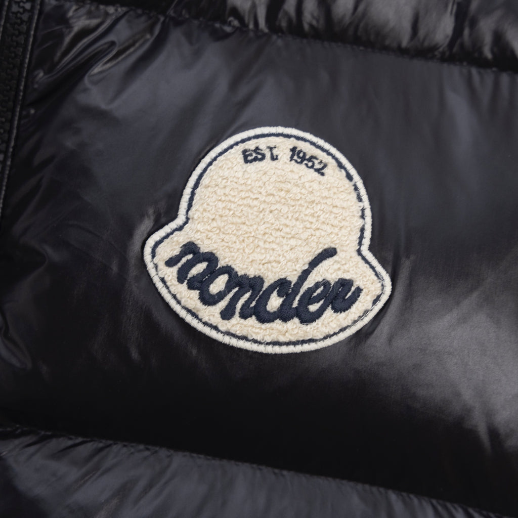 Moncler embroidered logo patch on black puffer vest fabric