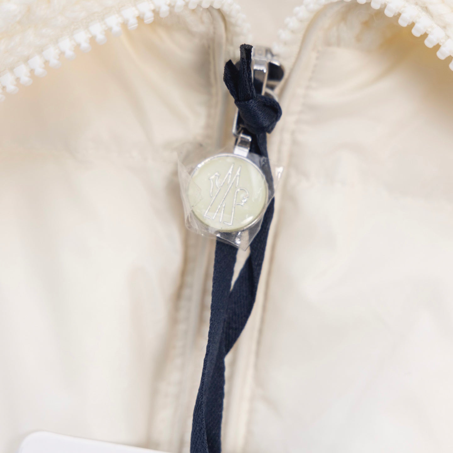 Moncler white puffer jacket, metal zipper pull with navy fabric trim