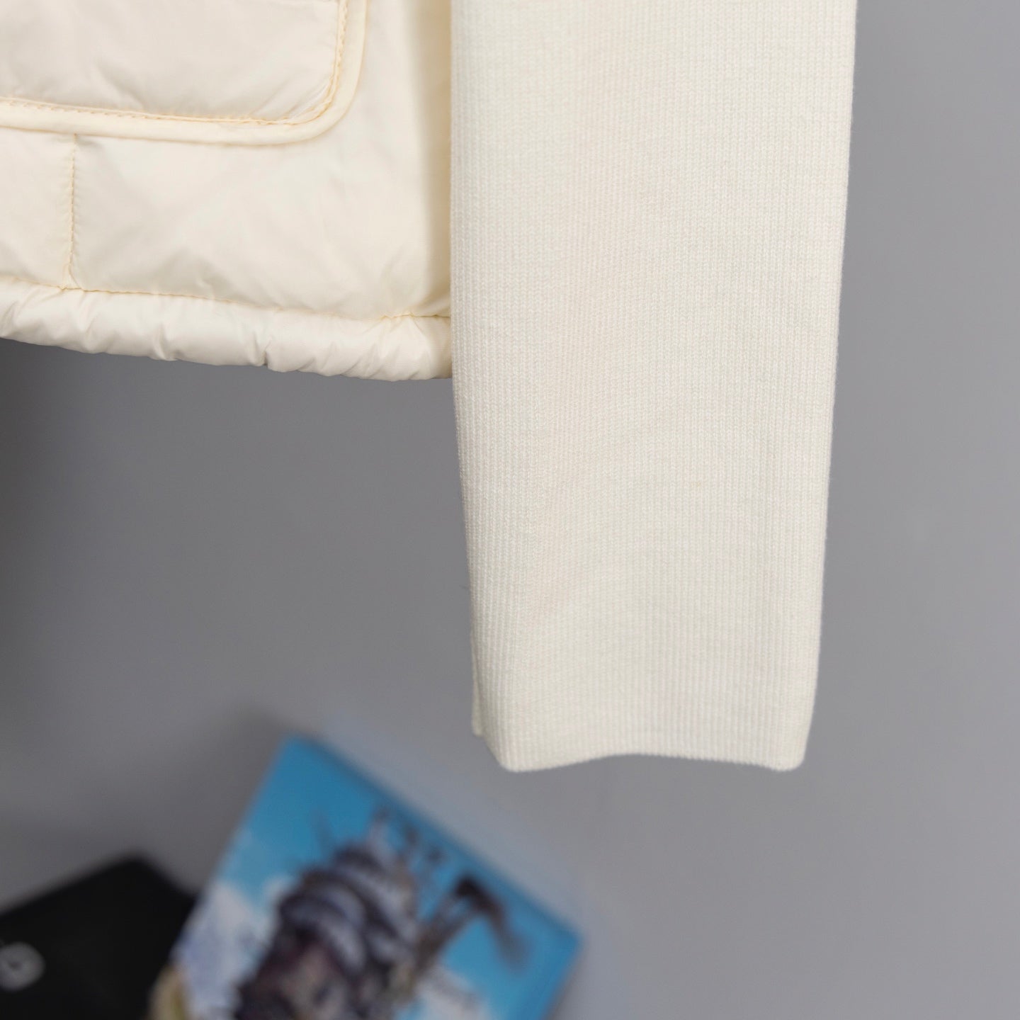 Moncler long puffer jacket ribbed sleeve cuff on cream fabric