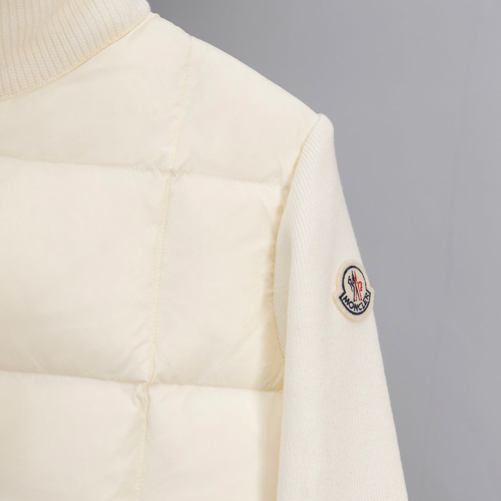 Moncler puffer jacket sleeve with small oval logo patch, cream quilted fabric