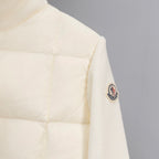 Moncler puffer jacket sleeve with small oval logo patch, cream quilted fabric