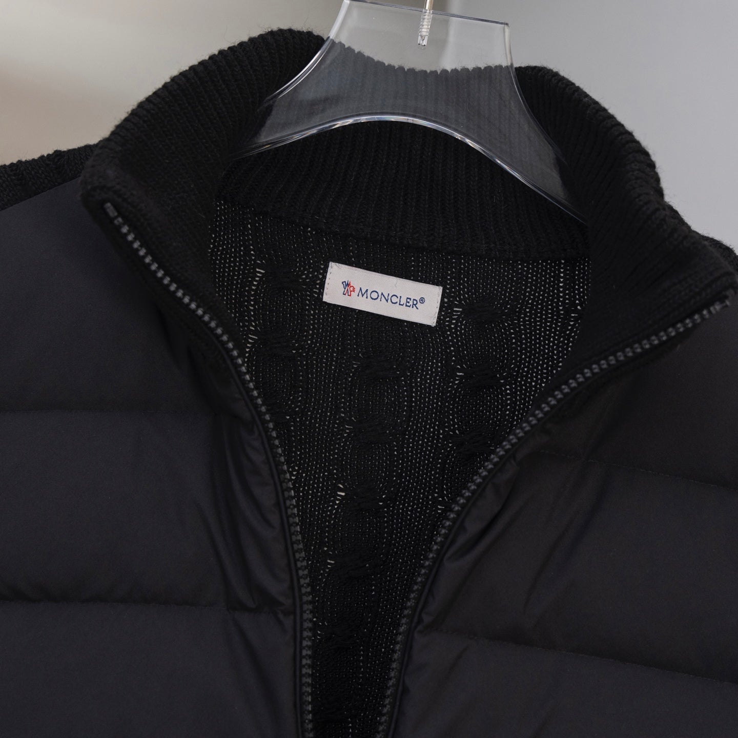 Moncler puffer jacket front close-up with zip and Moncler logo patch label