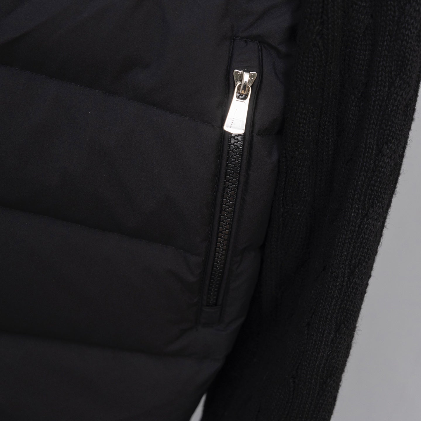 Moncler puffer jacket zipper and quilted panel detail on knit sleeve