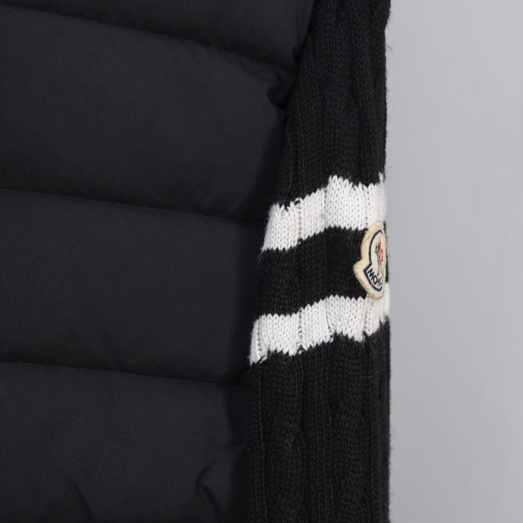 Moncler puffer jacket sleeve with striped knit cuff and round logo patch
