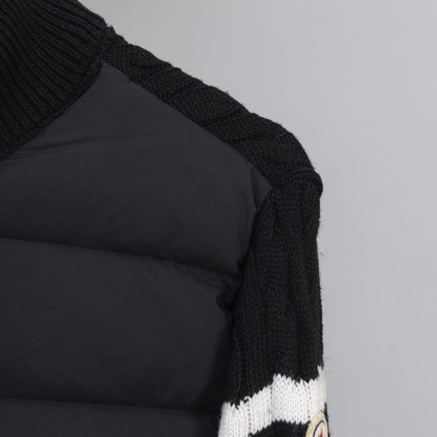 Moncler puffer jacket shoulder and sleeve with black quilted panel detail