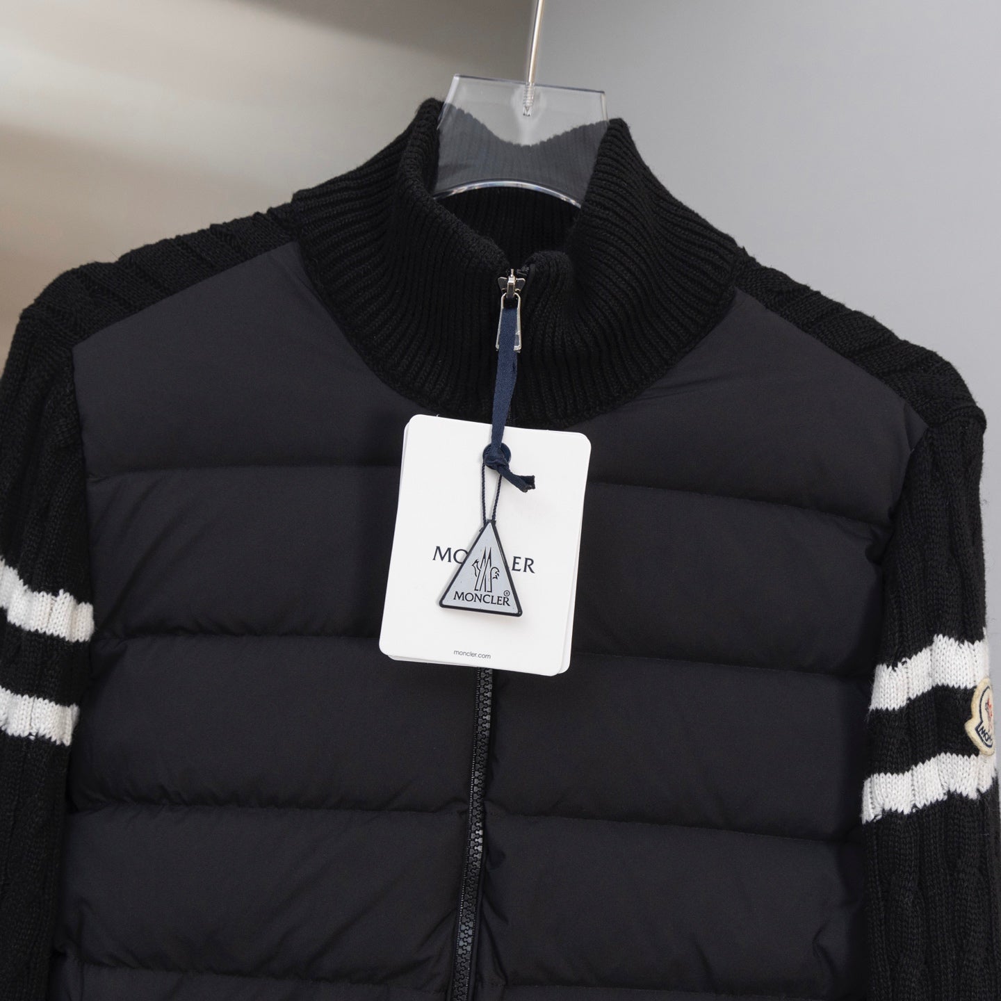 Moncler puffer jacket with ribbed knit stand collar and front zip, branded hang tag