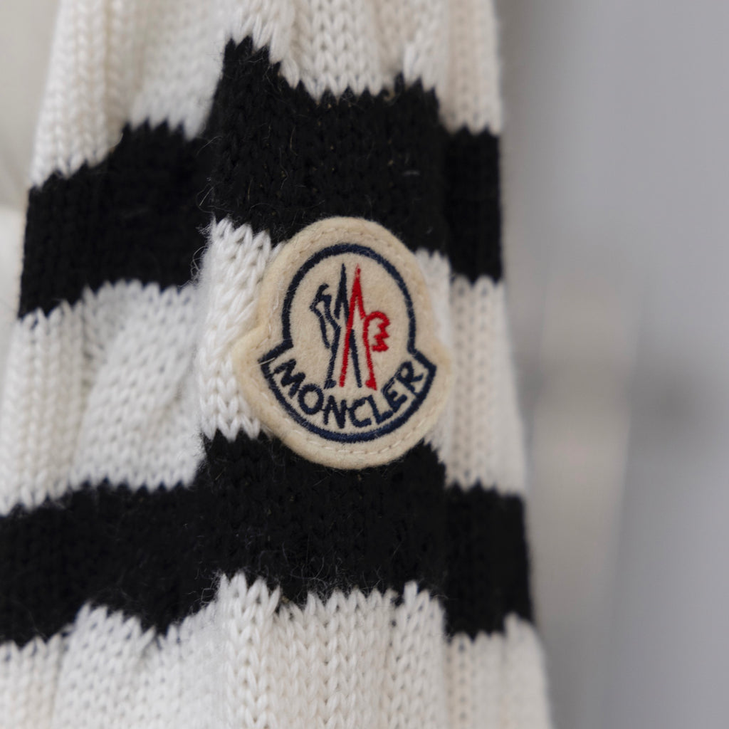 Moncler crest patch on knit sleeve, white and black striped pattern