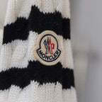 Moncler crest patch on knit sleeve, white and black striped pattern