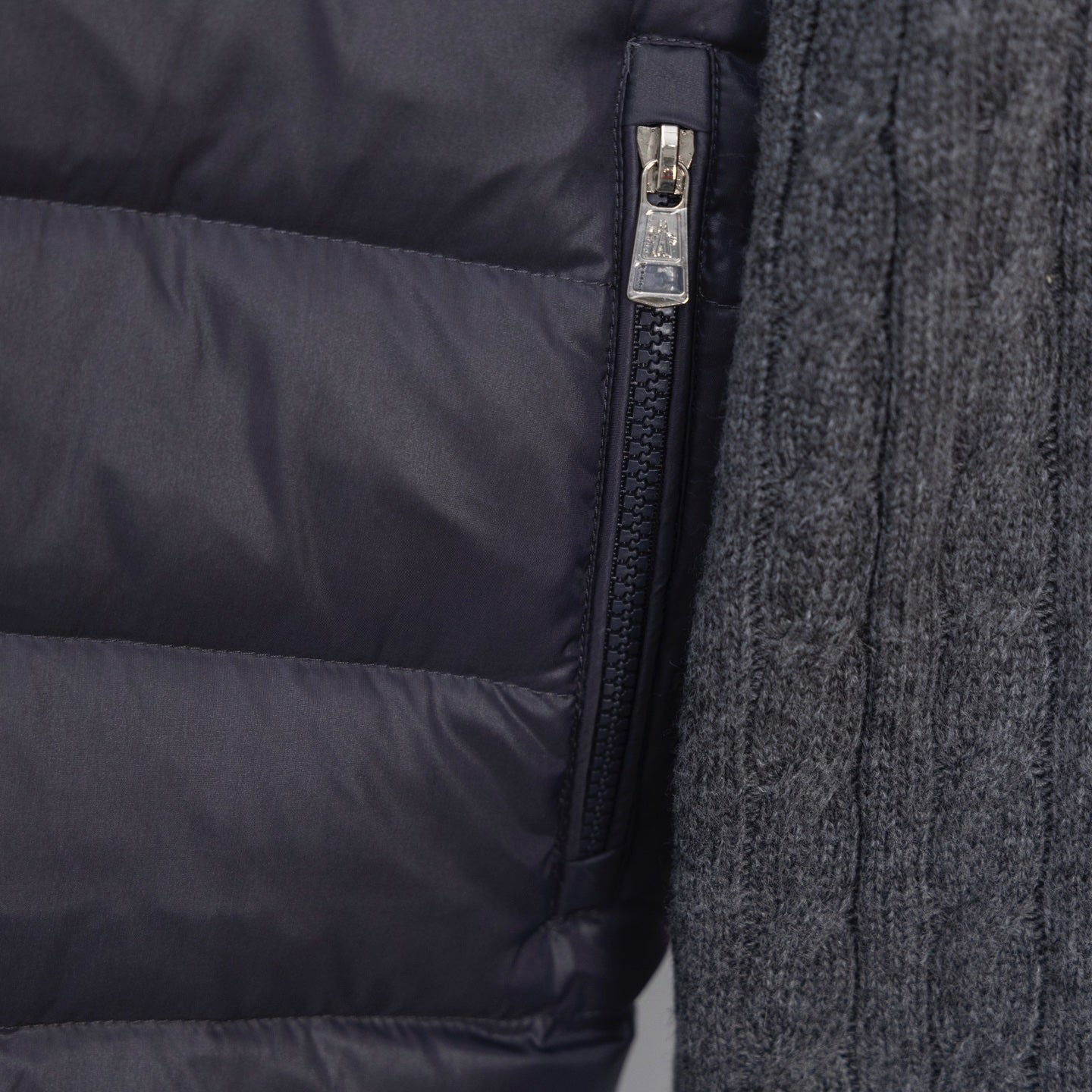 Moncler puffer jacket close-up of front zipper and knit sleeve trim