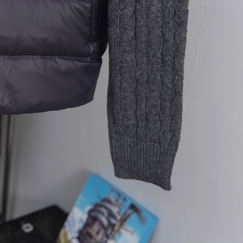 Long dark puffer jacket with gray ribbed knit section