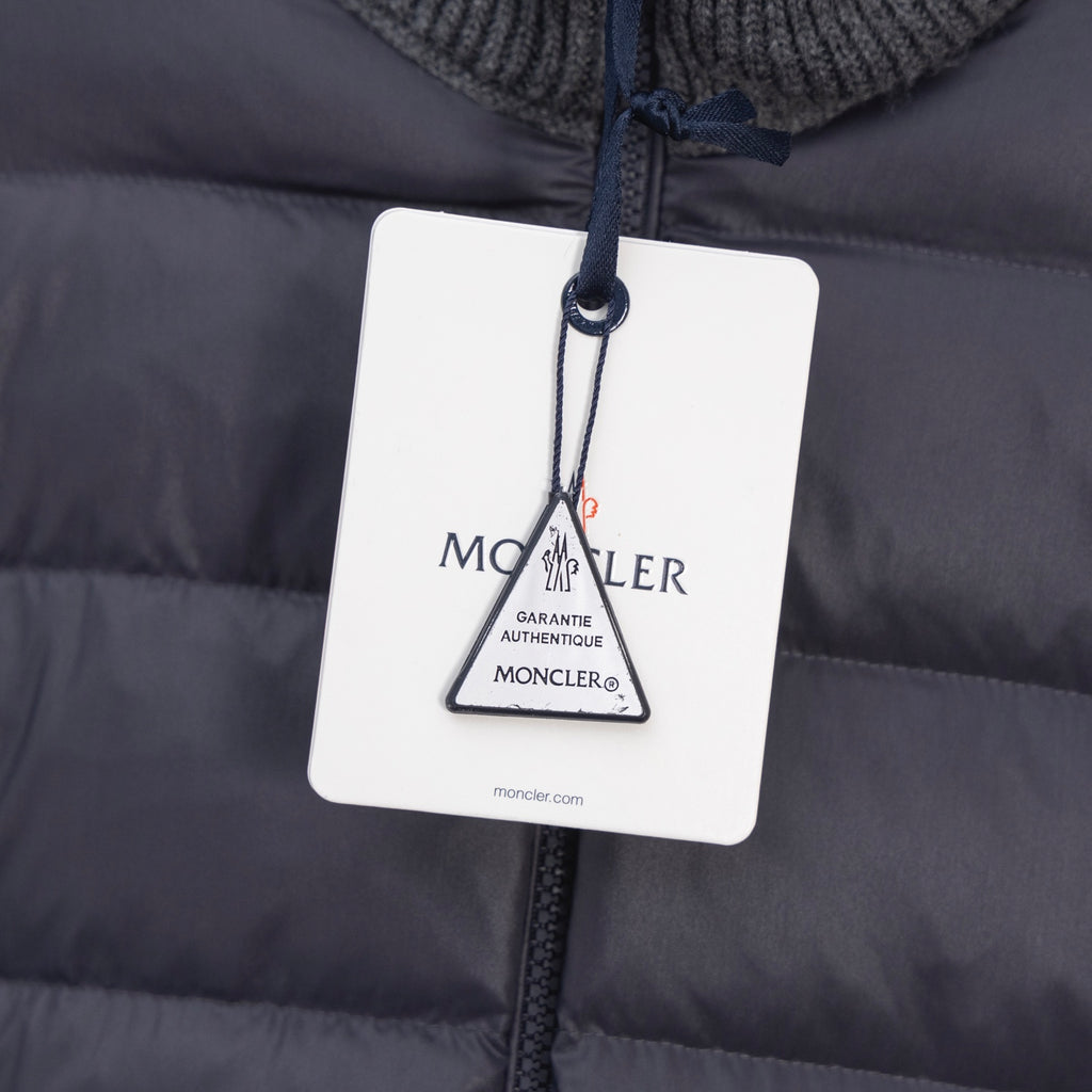 Moncler puffer jacket with hanging authenticity tag attached to front zip