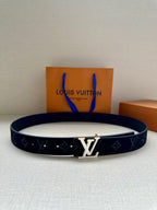 Dark navy leather belt with repeating monogram pattern and gold-tone center buckle
