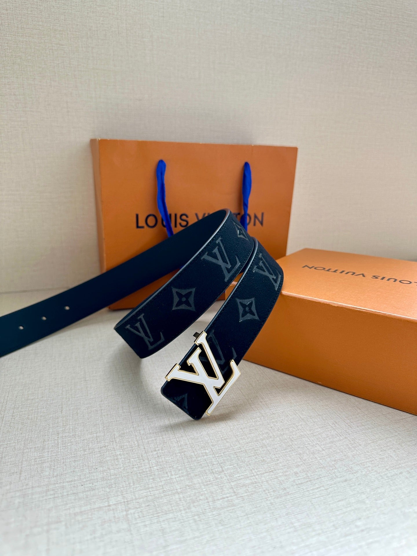 Dark navy monogram belt with oversized gold-tone LV buckle detail