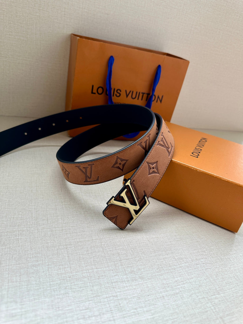 Tan monogram belt with gold LV buckle and blue inner strap