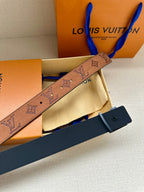 Tan monogram belt with blue inner strap and dark buckle piece