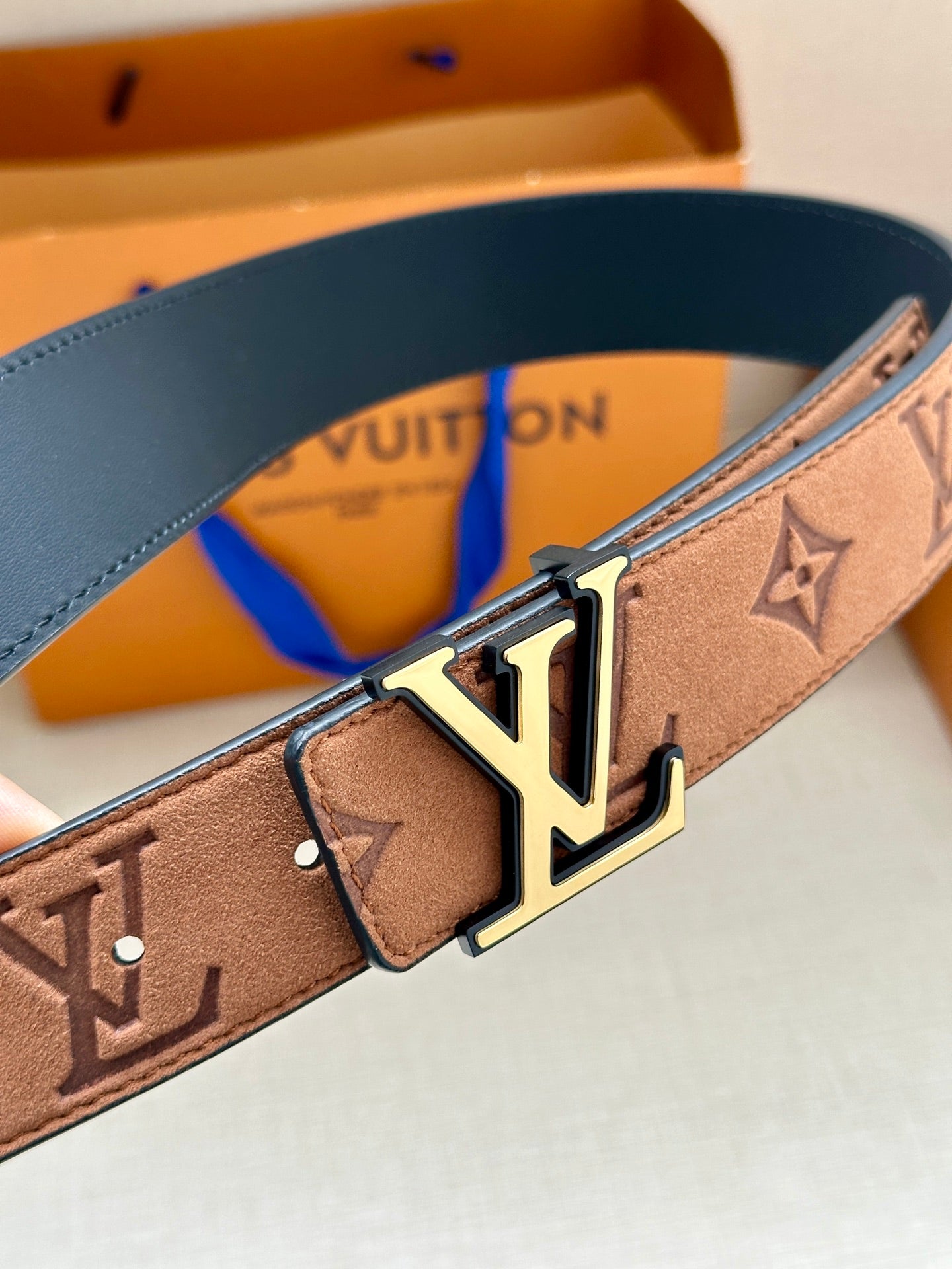 Tan monogram belt with gold LV buckle and blue inner strap