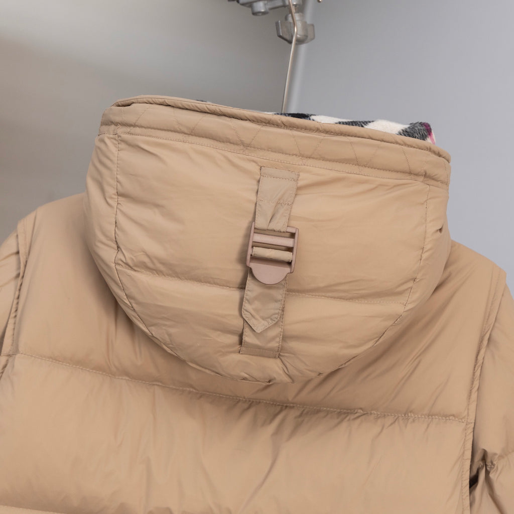 Beige puffer jacket hood with snap strap and Burberry hang tag