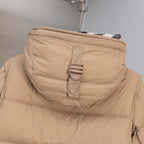 Beige puffer jacket hood with snap strap and Burberry hang tag