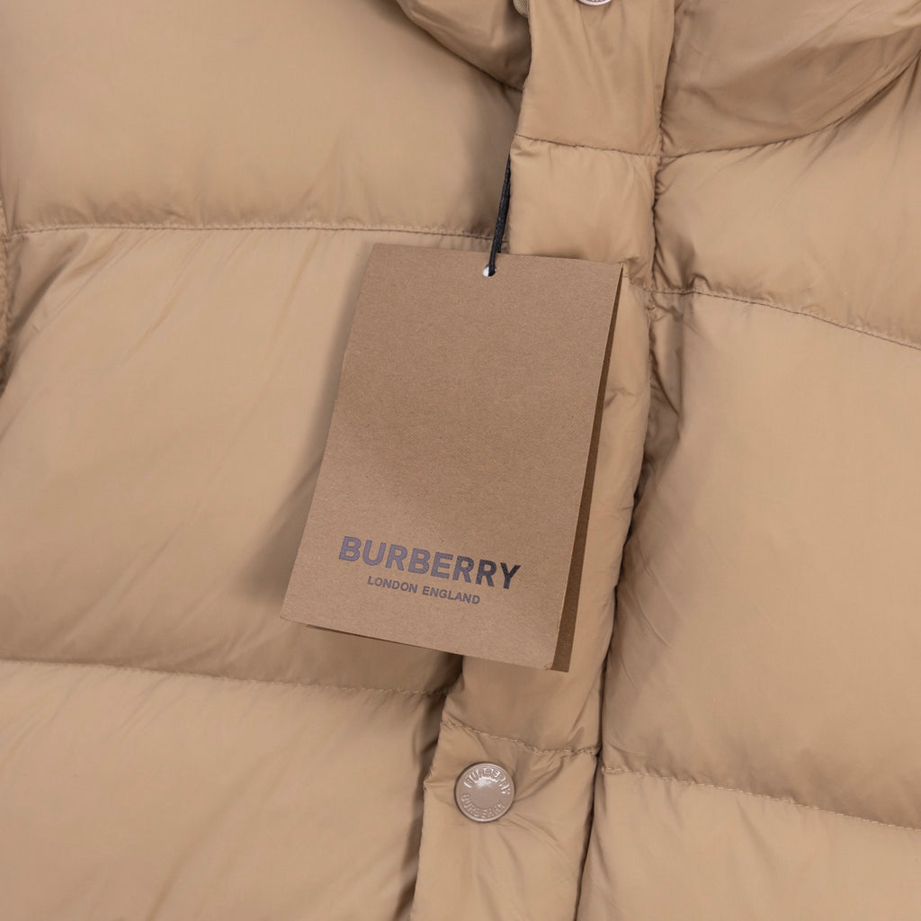 Beige puffer jacket front with Burberry hang tag and snap buttons