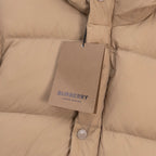 Beige puffer jacket front with Burberry hang tag and snap buttons