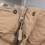 Beige puffer jacket front with zipper, snap buttons, Burberry detail