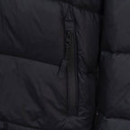 Black puffer jacket close-up of center front zipper and pocket trim
