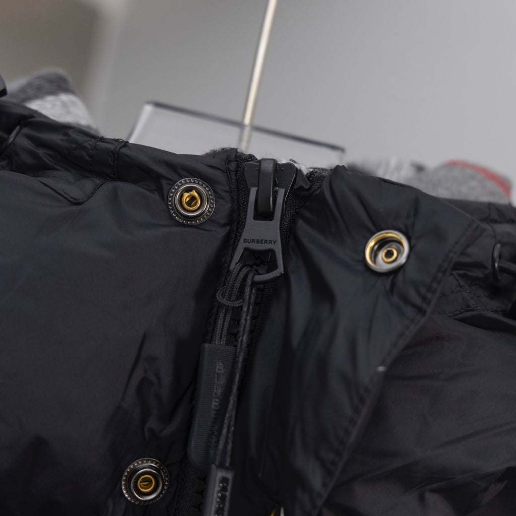 Dark hooded jacket collar with snap buttons and Burberry logo patch