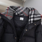 Hooded puffer jacket in black with plaid hood lining and snap-button collar