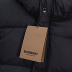 Black puffer jacket with hood snap and round logo badge near the placket