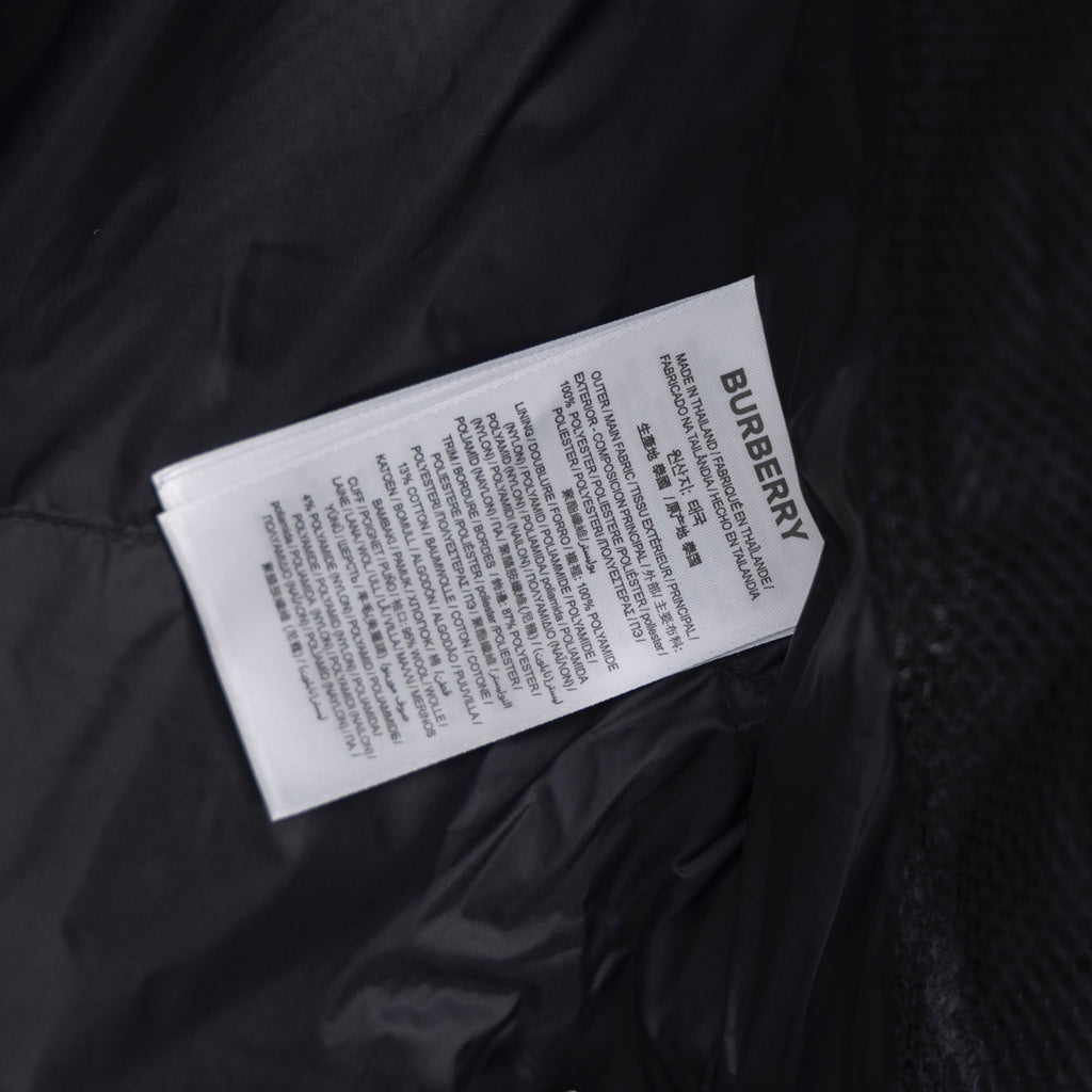 Burberry fabric care label inside dark puffer jacket lining