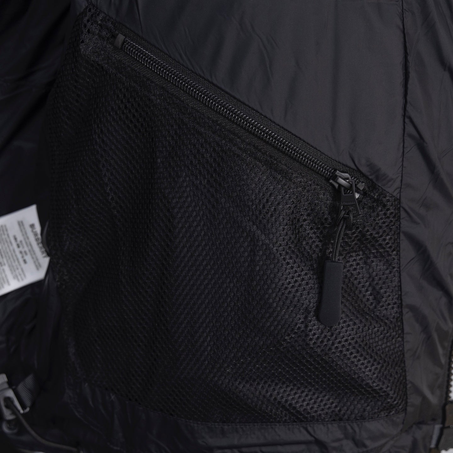 Dark jacket lining with mesh pocket and zip closure
