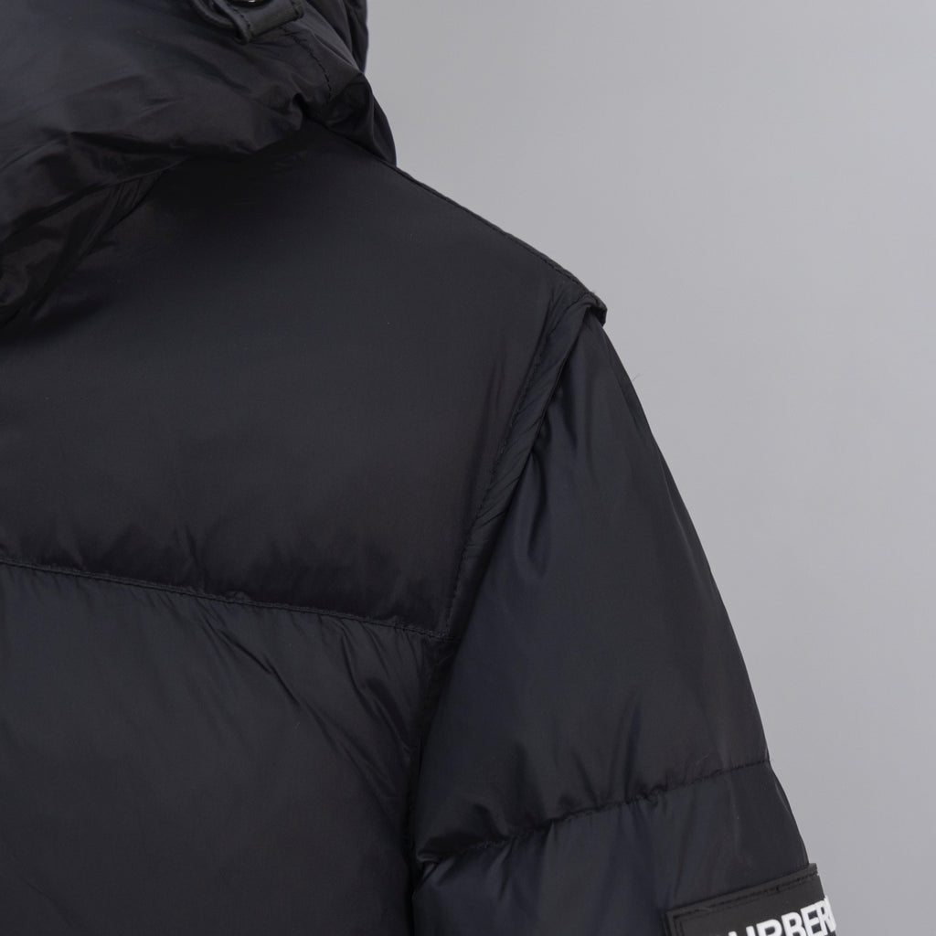Dark puffer jacket with stitched paneling and high collar