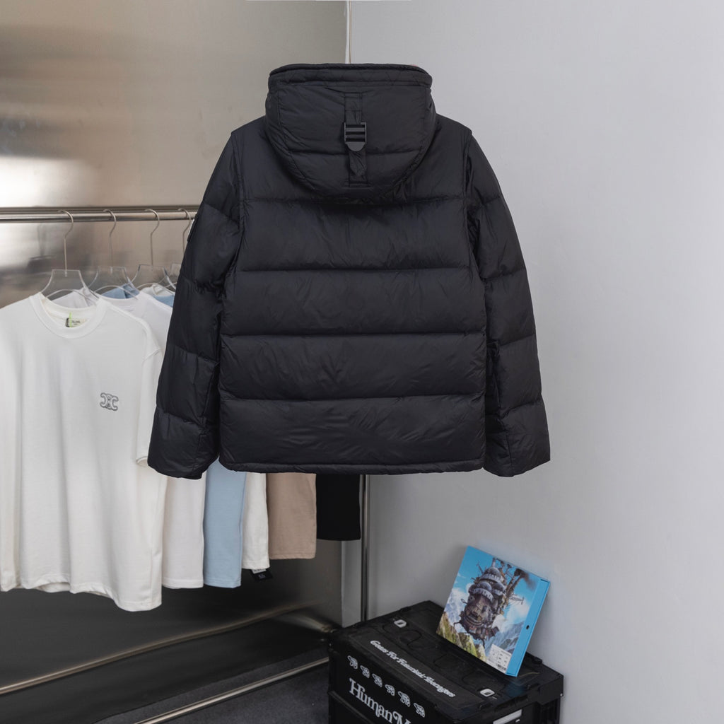 Hooded long puffer jacket in black with a high collar and zipped front