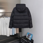 Hooded long puffer jacket in black with a high collar and zipped front