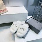 White fuzzy slide sandals with rhinestone bow strap, open-toe design