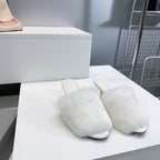 Balenciaga white faux fur slide sandals, side view, low stiletto heel