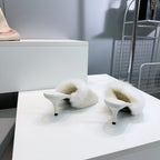 Balenciaga white faux fur slide sandals with curved straps and low stiletto heels