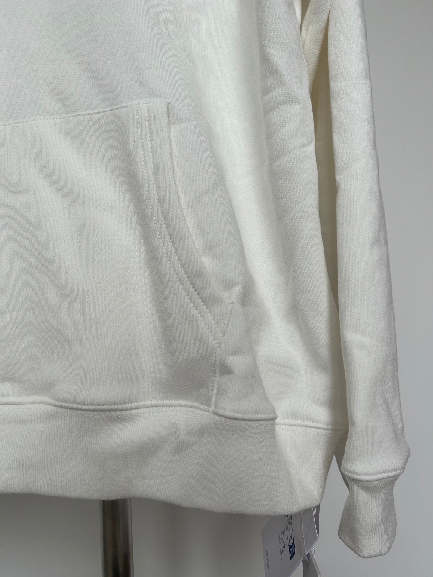 Off-white hoodie front pocket and curved hem with clean stitched seams