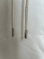 Off-white hoodie close-up of drawstring tips and stitched seam near pocket
