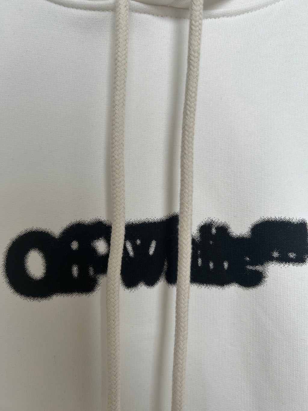 Off-white hoodie logo print with hanging drawstrings and hood opening