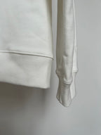 Off-white hoodie cuff and side hem close-up with smooth fabric texture