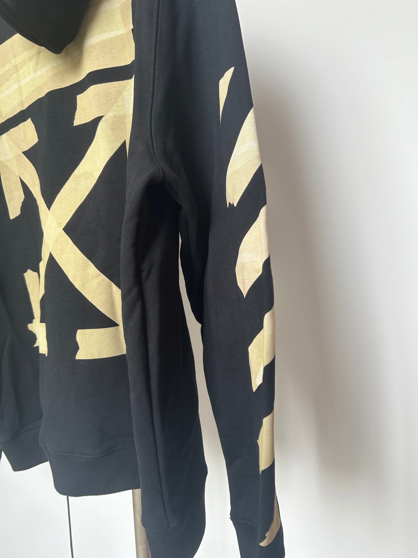Off-White navy hoodie side panel with gold graphic and kangaroo pocket