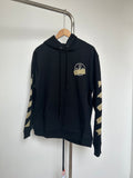 Zip-up hoodie in dark navy with drawstring hood and chest logo patch.