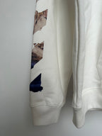 Off-White hoodie sleeve detail with multicolor graphic patches and ribbed cuff