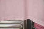 Light pink T-shirt hem with stitched seam
