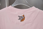 Light pink T-shirt back with small multicolor emblem near neckline