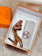 Hermes women’s heeled sandals in box with tan straps and matching dust bag