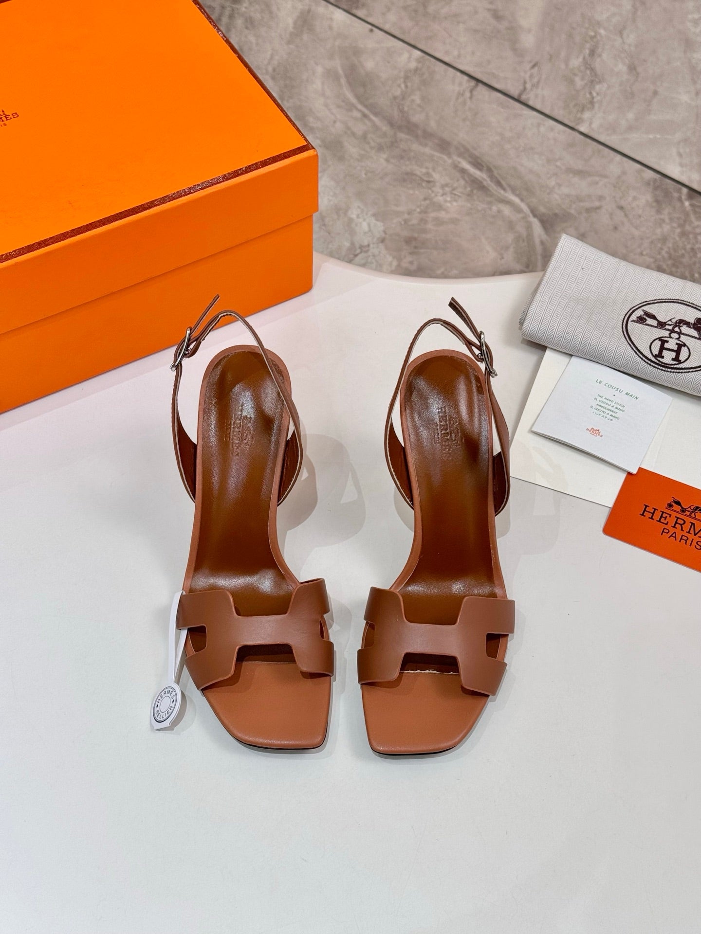 Hermes women’s leather heeled sandals, tan back view with ankle strap and heel