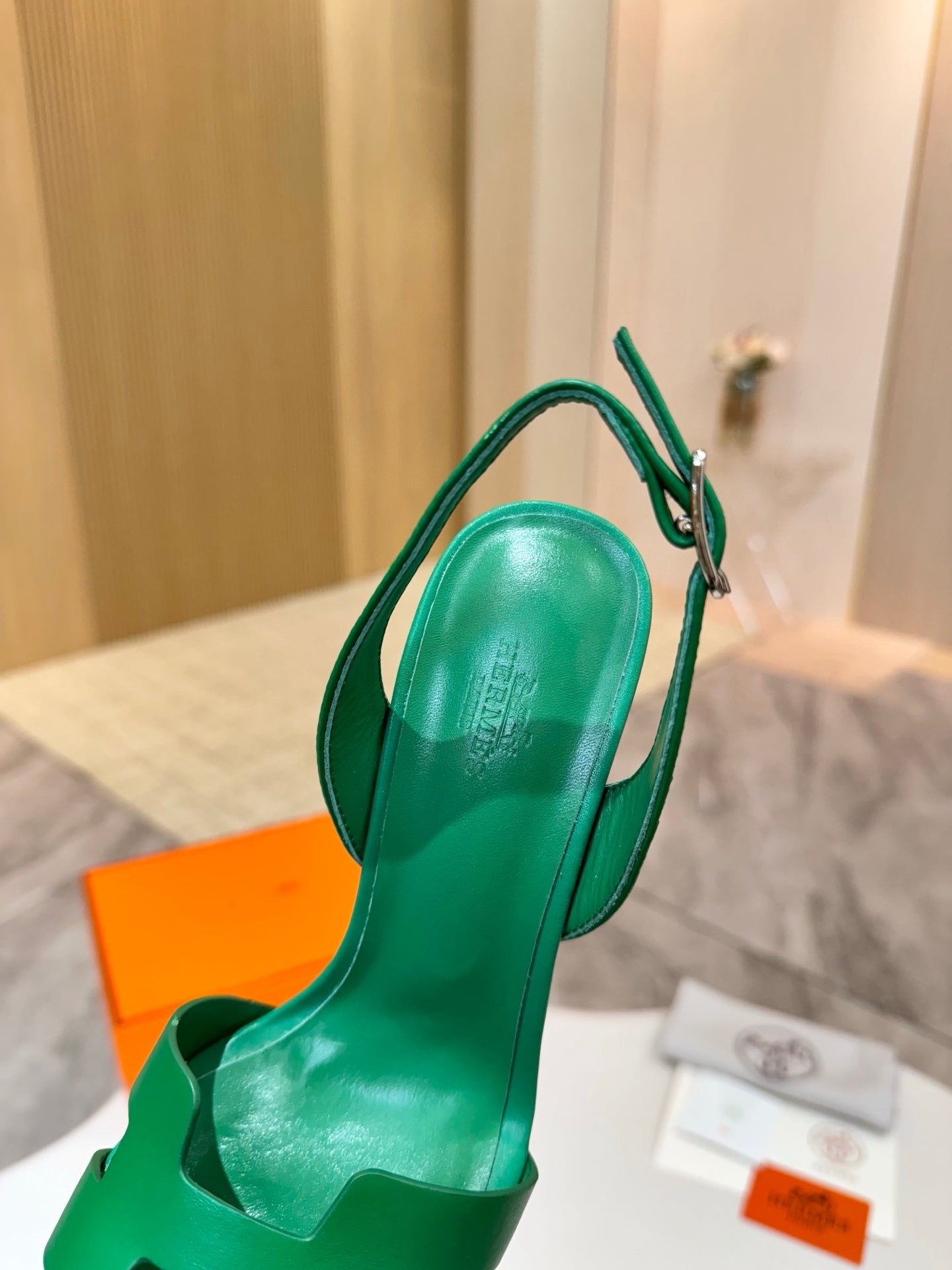 Green slingback high-heel sandal with curved open-toe and ankle strap