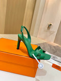 Green strappy high-heel sandal with open toe and buckled ankle strap
